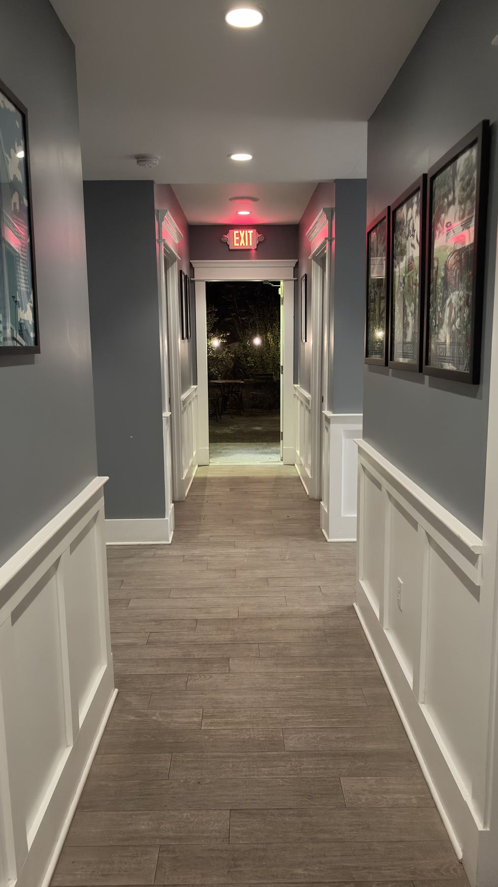 The hallway lined with framed artwork