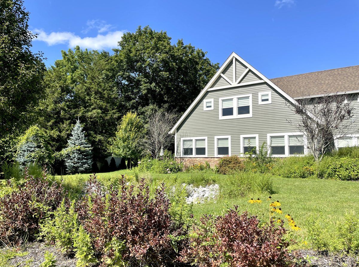 Side of building with garden, late summer
