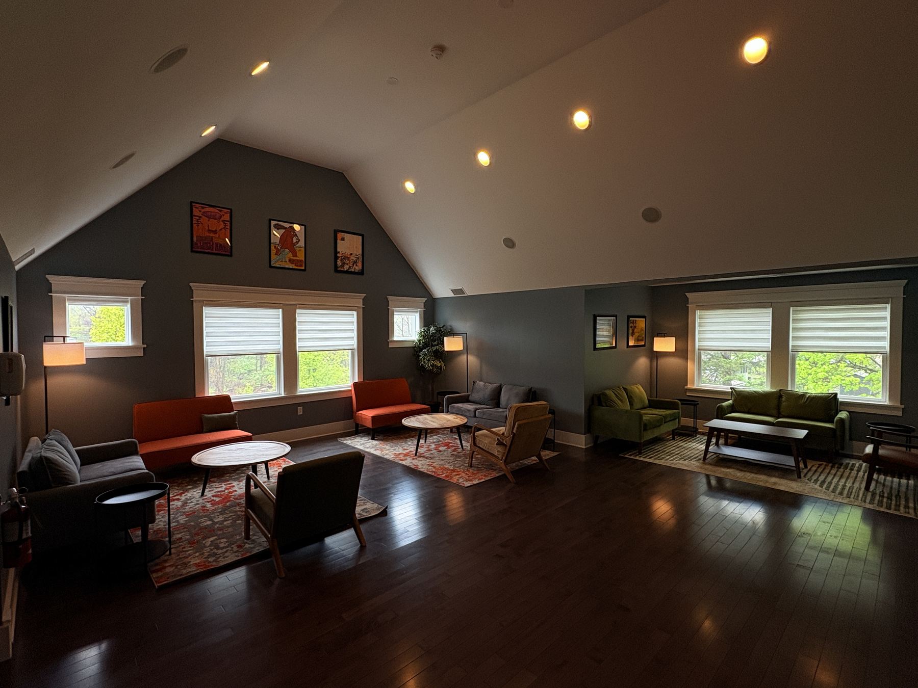 The lounge in the private party space — mid-century sofas and big windows